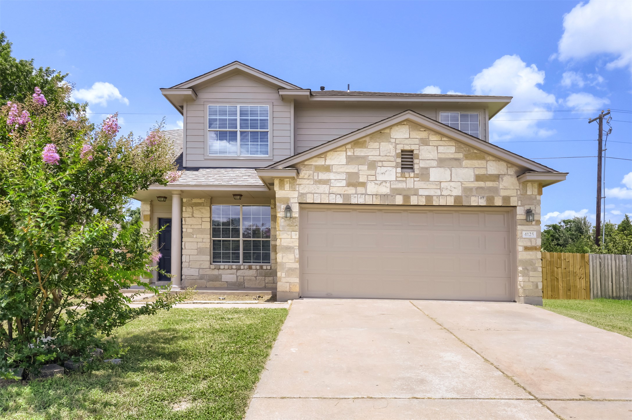 4125 Pebble Ridge Cove Round Rock, TX 78681 - Photo 2 of 30 A classic two-story home features a harmonious blend of stone and siding, presenting inviting curb appeal.
