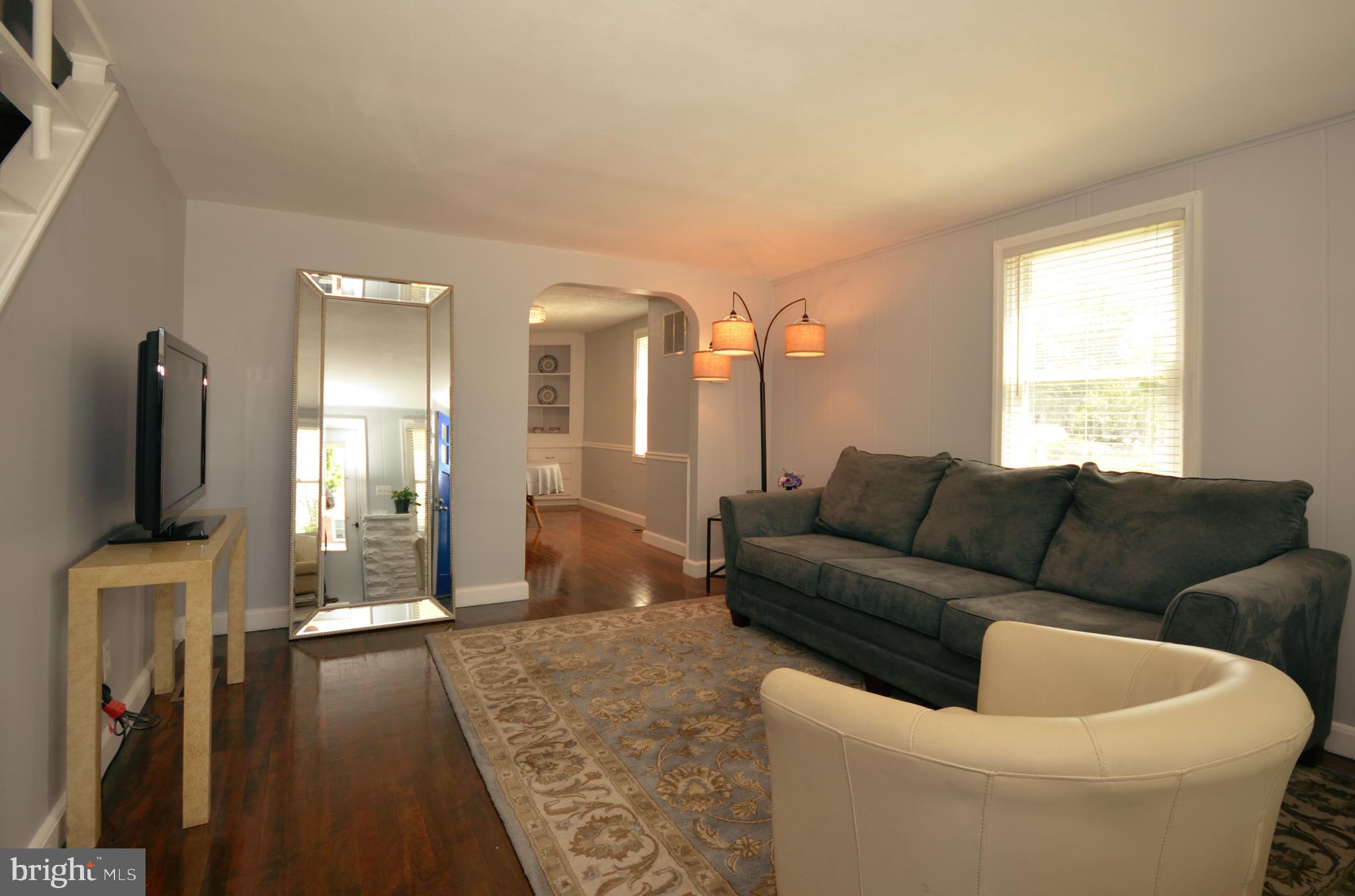 3665 Clarenell Road Baltimore, MD 21229 - Photo 20 of 42 Light-filled living room, gleaming hardwoods