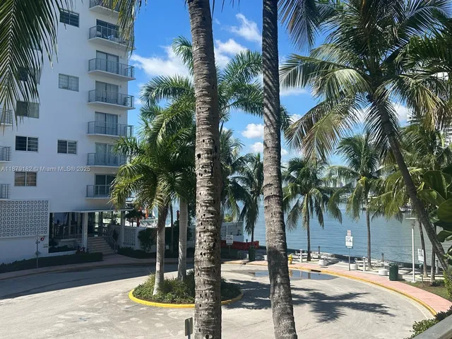 a view of a palm trees in front of a building