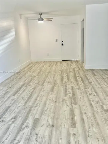 an empty room with large windows