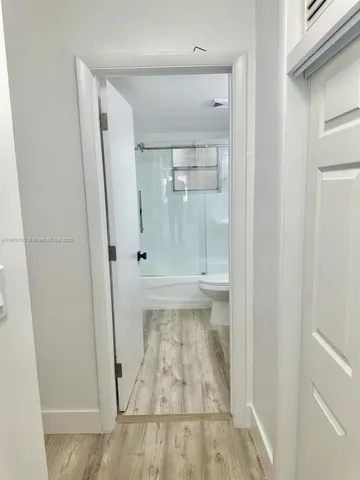 a bathroom with a toilet and a shower