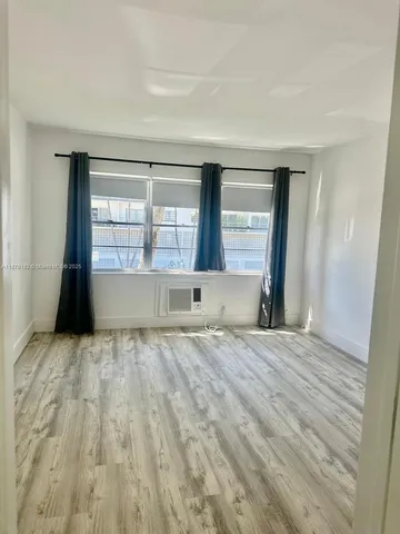 a view of wooden floor and windows