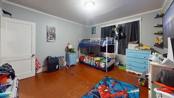 a bedroom with furniture and a flat screen tv
