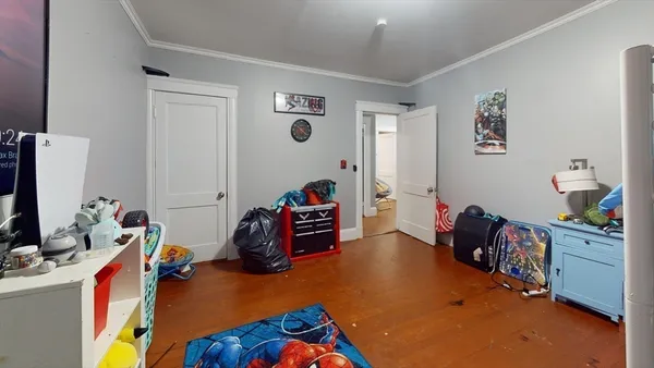 a bedroom with a bed and a flat tv screen