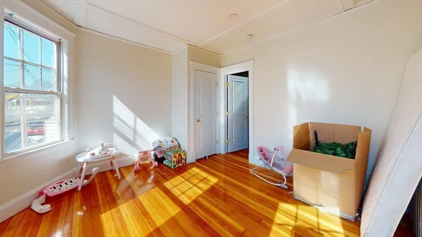 a kitchen with stainless steel appliances a sink a stove a refrigerator cabinets and a dining table