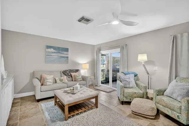 a living room with furniture and a lamp
