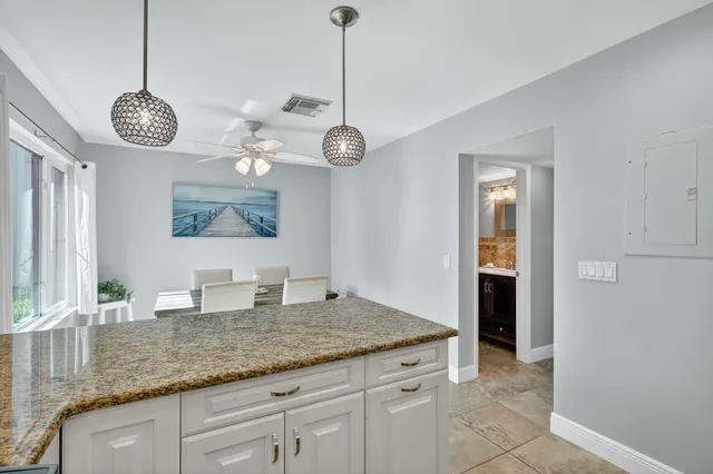 a kitchen with a counter space and a view of living room