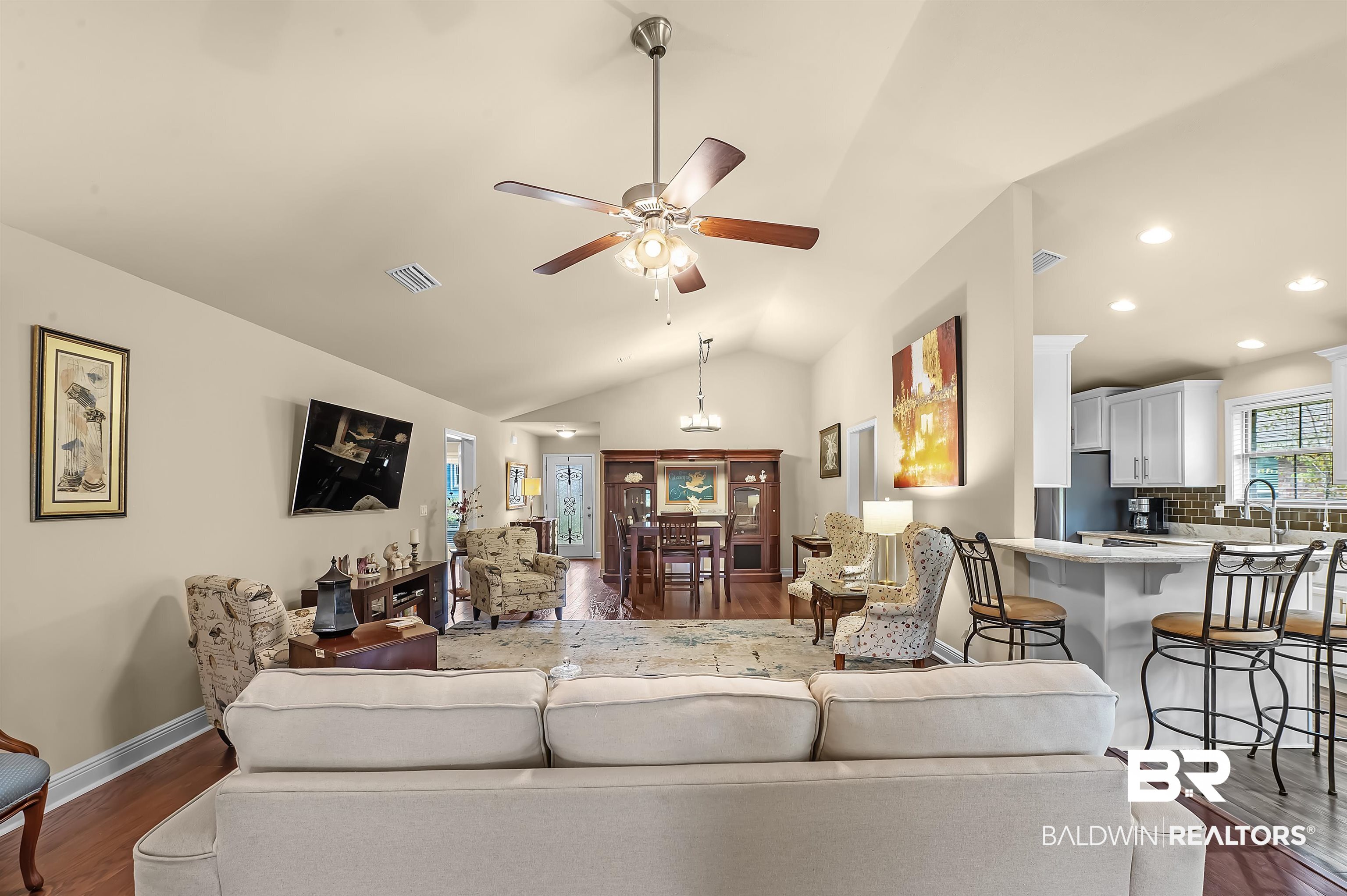 8896 Allay Lane Foley, AL 36535 - Photo 24 of 57 Living room featuring lofted ceiling, sink, ceiling fan, and dark hardwood / wood-style flooring