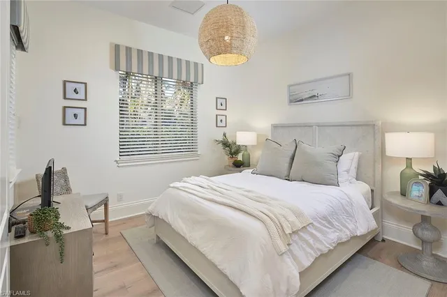 a bedroom with bed and window