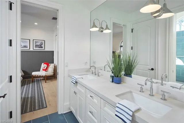 a bathroom with a double vanity sink and a mirror