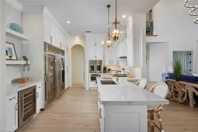 a kitchen with a sink a counter space and stainless steel appliances