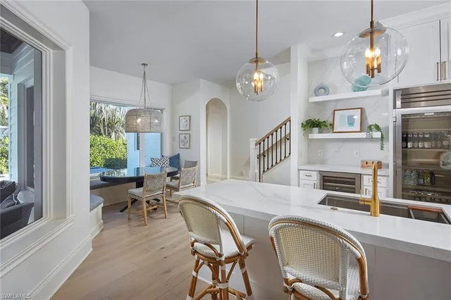 a view of a dining room with furniture a chandelier and wooden floor
