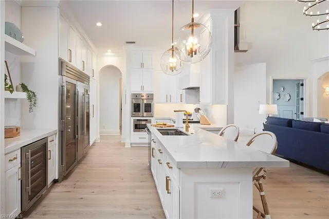 a large kitchen with stainless steel appliances lots of counter space and window