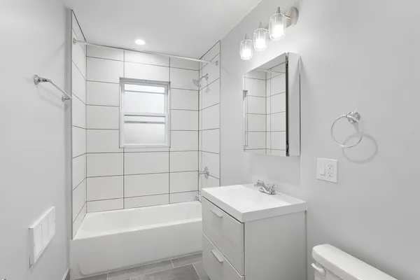 a bathroom with a bathtub a sink and a shower