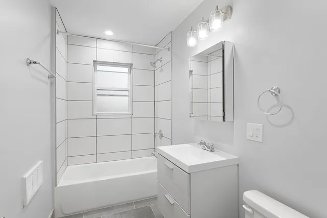 a bathroom with a bathtub a sink and a shower