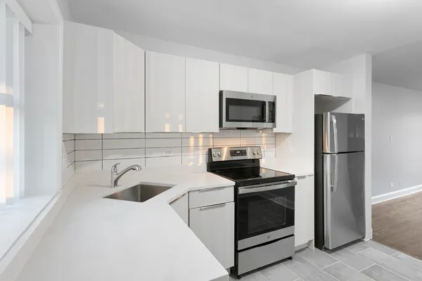 a kitchen with appliances a sink and a counter top space