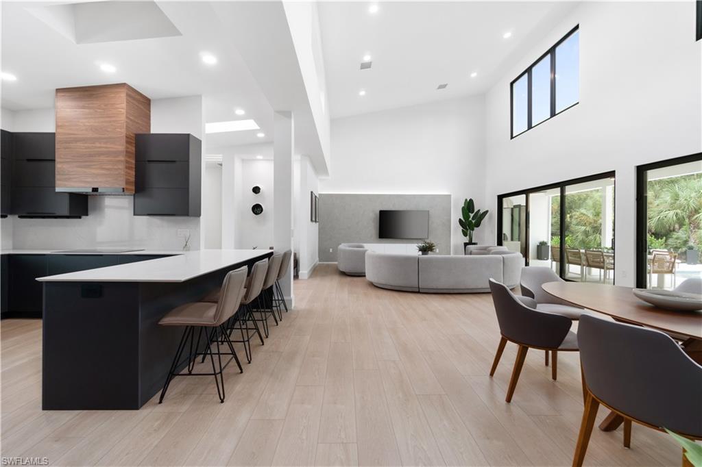 13865 Collier Boulevard Naples, FL 34119 - Photo 24 of 50 Bedroom with light hardwood / wood-style floors, a spacious closet, and multiple windows