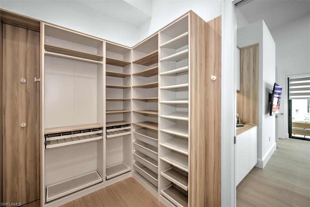 13865 Collier Boulevard Naples, FL 34119 - Photo 29 of 50 Bathroom with double sink vanity and tile patterned floors