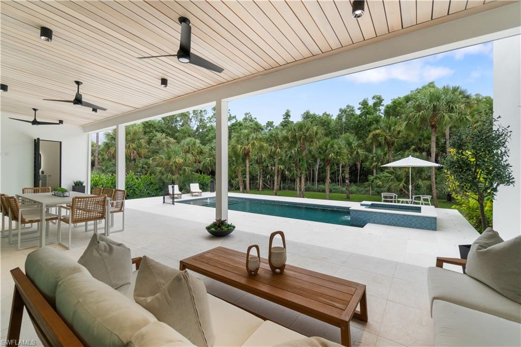 13865 Collier Boulevard Naples, FL 34119 - Photo 3 of 50 Outdoor area overlooking the pool and preserve with large patio, electric bug screen, outdoor kitchen and full pool bathroom
