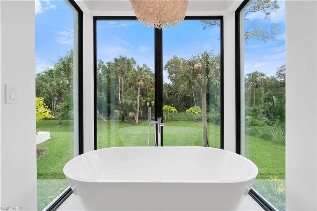 13865 Collier Boulevard Naples, FL 34119 - Photo 31 of 50 Bathroom with tile patterned flooring, shower with separate bathtub, and a healthy amount of sunlight