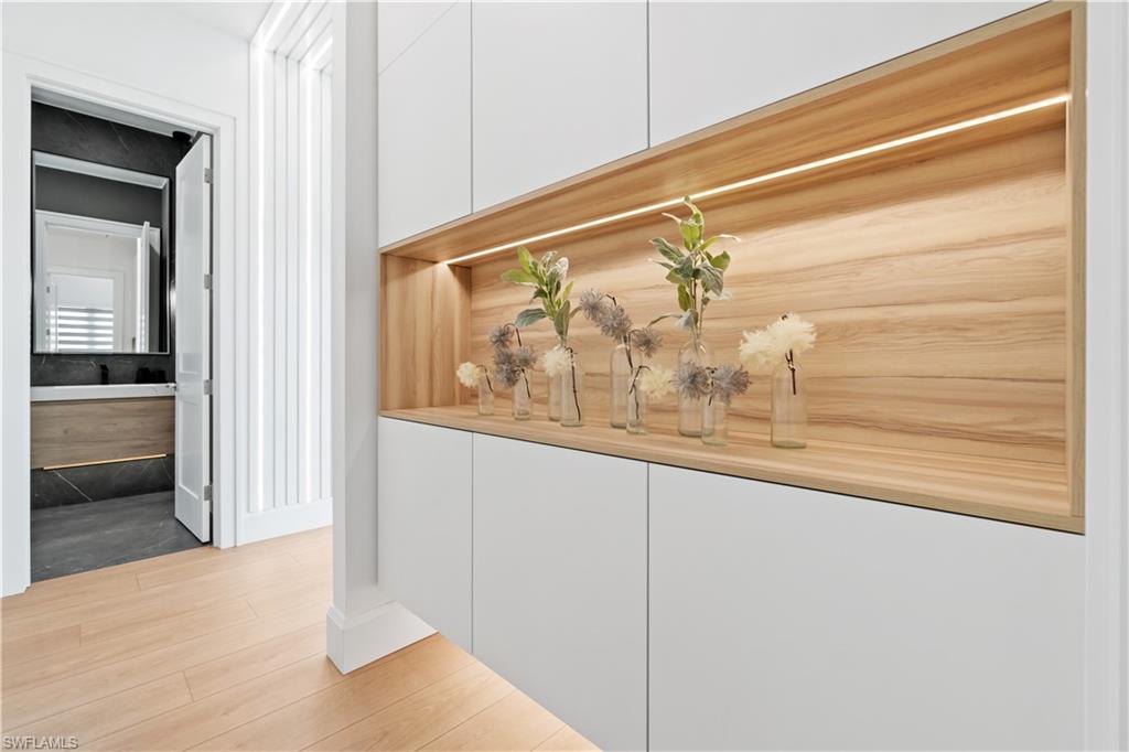 13865 Collier Boulevard Naples, FL 34119 - Photo 35 of 50 Bathroom featuring toilet, an enclosed shower, vanity, tile walls, and tile patterned floors
