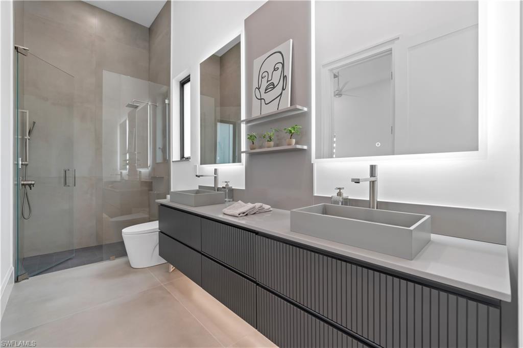13865 Collier Boulevard Naples, FL 34119 - Photo 37 of 50 Bathroom with toilet, walk in shower, and vanity