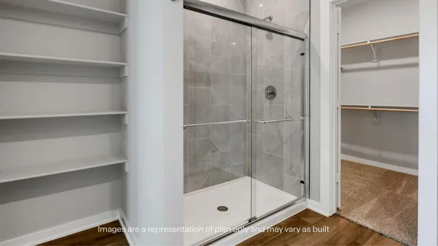 a bathroom with a glass shower door