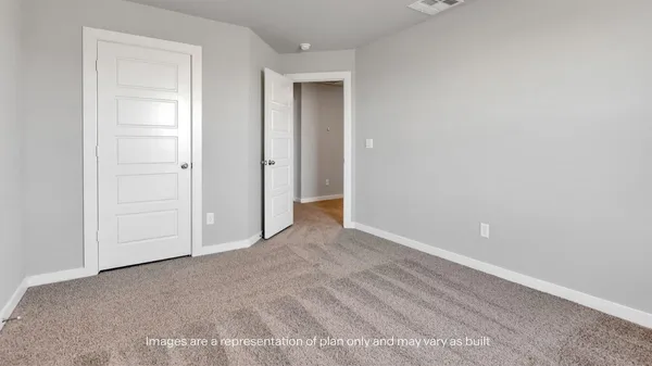 a view of an empty room with closet area
