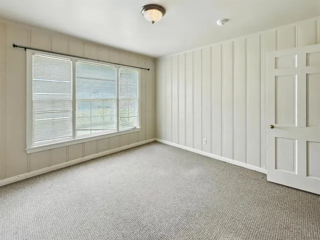a view of an empty room with a ceiling fan