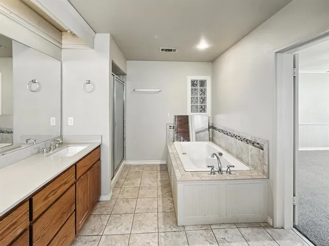 a spacious bathroom with a granite countertop sink and a mirror