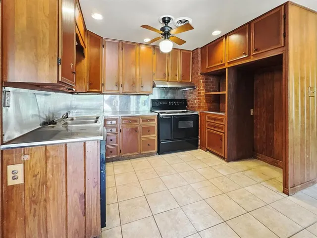 a kitchen with stainless steel appliances granite countertop a stove a sink dishwasher and a refrigerator