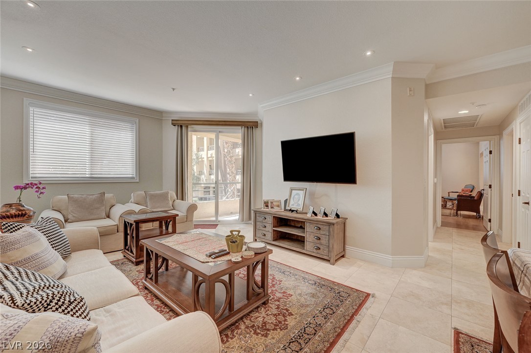 230 East Flamingo Road, Unit 106 Las Vegas, NV 89169 - Photo 1 of 66 An inviting living room features elegant crown molding and ample recessed lighting, perfect for entertaining.
