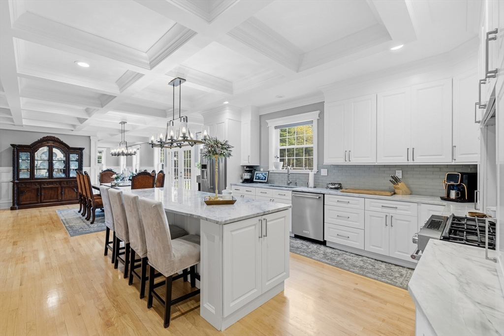 35 High Street Freetown, MA 02702 - Photo 22 of 40 a kitchen with a dining table chairs sink and cabinets