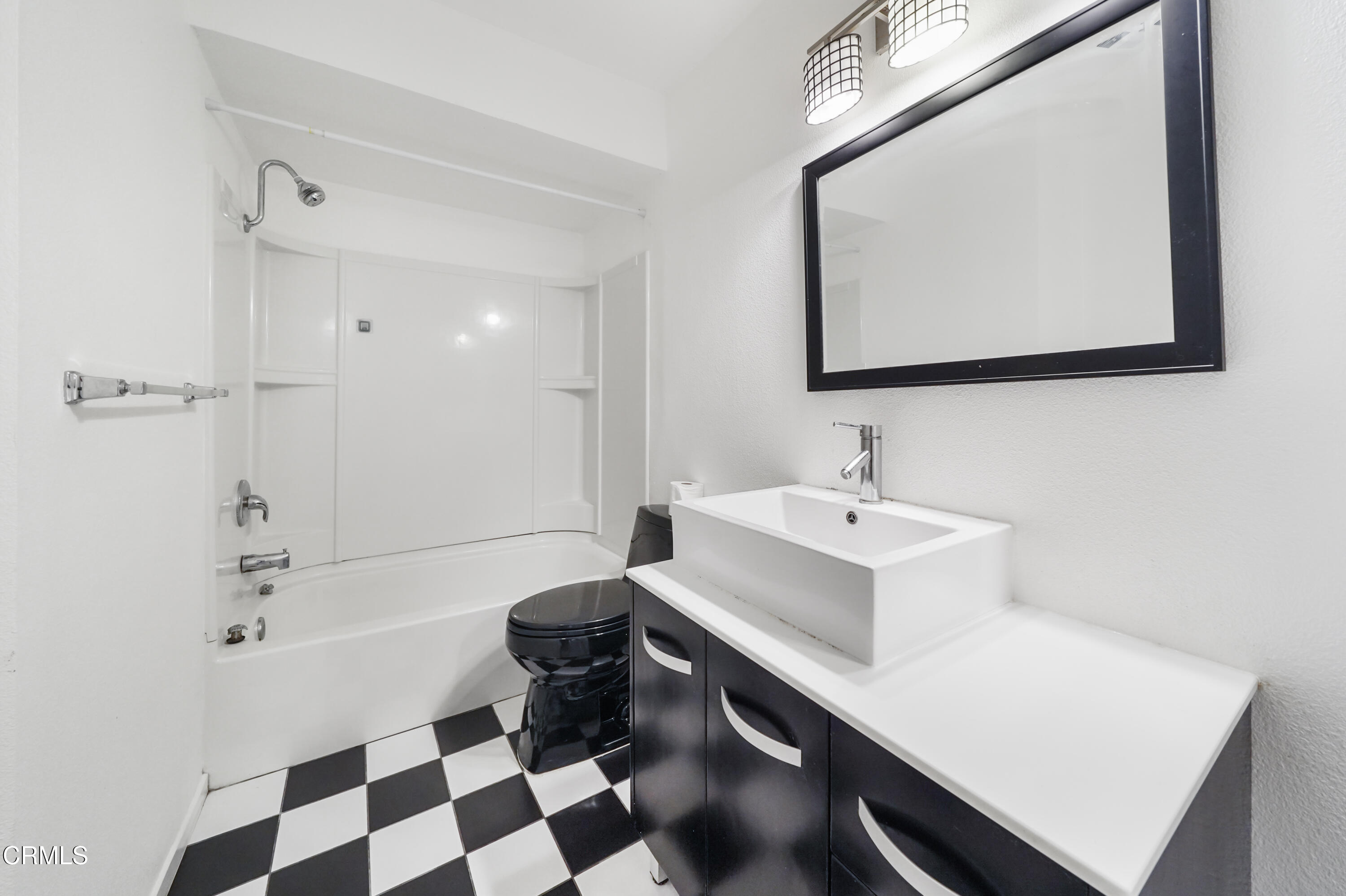 3101 Peninsula Road, Unit 107 Oxnard, CA 93035 - Photo 16 of 24 a bathroom with a sink a toilet a mirror and shower