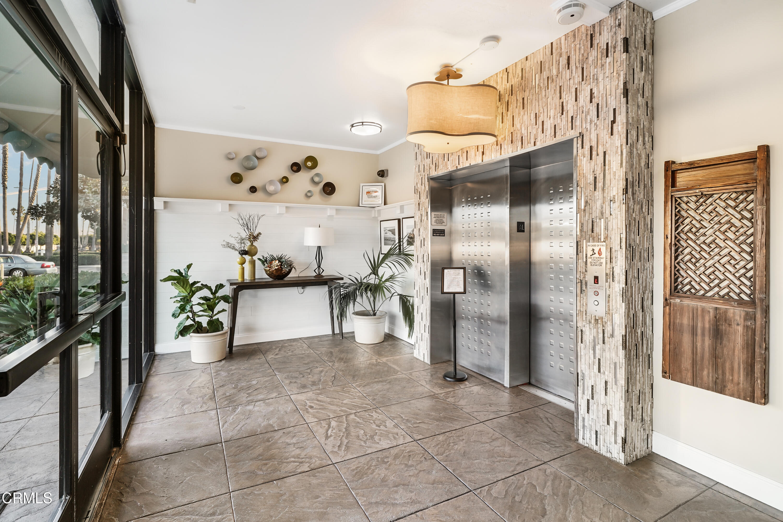 3101 Peninsula Road, Unit 107 Oxnard, CA 93035 - Photo 3 of 24 a view of a hallway with dining area and glass door