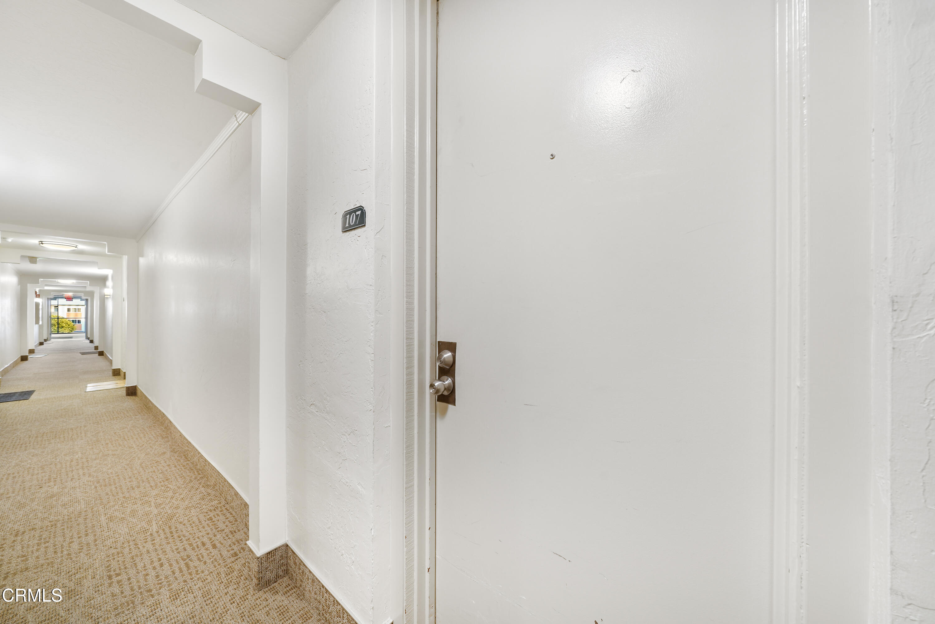 3101 Peninsula Road, Unit 107 Oxnard, CA 93035 - Photo 6 of 24 a view of a hallway with wooden floor