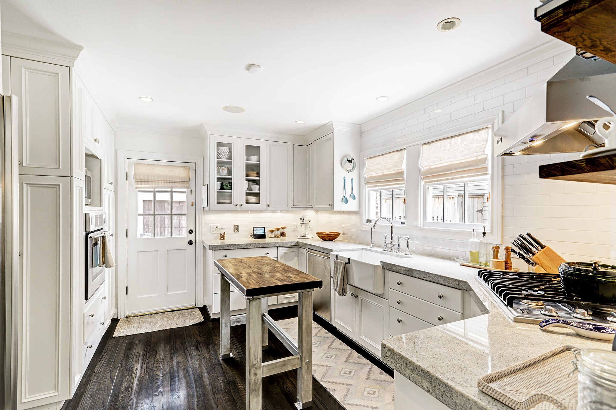 2829 Sunset Boulevard West University Place, TX 77005 - Photo 5 of 19 a kitchen with granite countertop a sink stove and cabinets