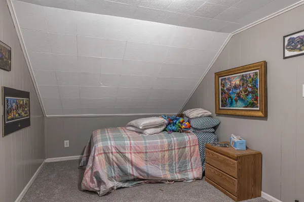 a bedroom with a bed and a couch