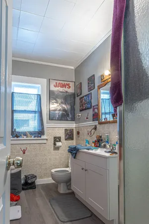 a kitchen with a white cabinets and window