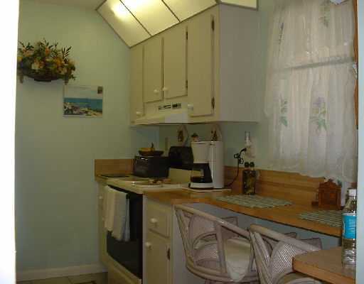 906 Southwest 9th St Circle, Unit 101 Boca Raton, FL 33486 - Photo 7 of 14 a kitchen with a sink and cabinets