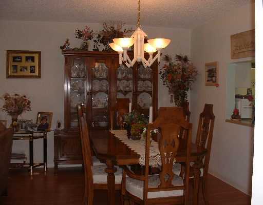 906 Southwest 9th St Circle, Unit 101 Boca Raton, FL 33486 - Photo 10 of 14 a view of a dining room with furniture and chandelier