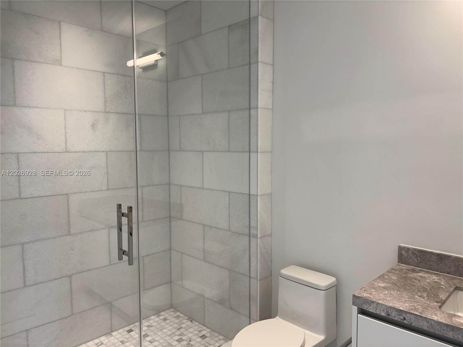 175 Southeast 25th Road, Unit 901 Miami, FL 33129 - Photo 17 of 18 a white toilet sitting next to a bathroom sink