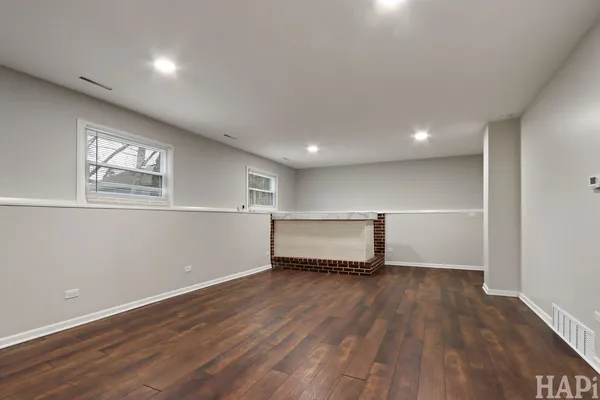 a view of a room with wooden floor and window