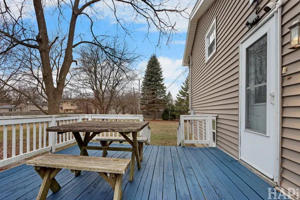a view of a deck with table and chairs and wooden floor