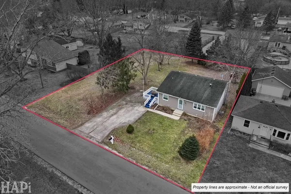 an aerial view of a house with a yard