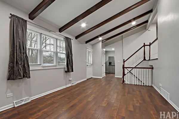 a view of an entryway with wooden floor