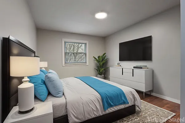 a bedroom with a bed and a flat screen tv