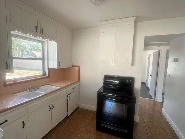 a kitchen with granite countertop a stove and a refrigerator