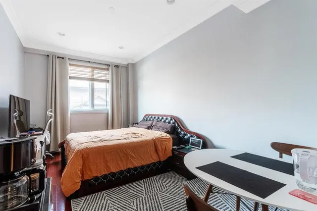 a large bed sitting in a bedroom with a hallway