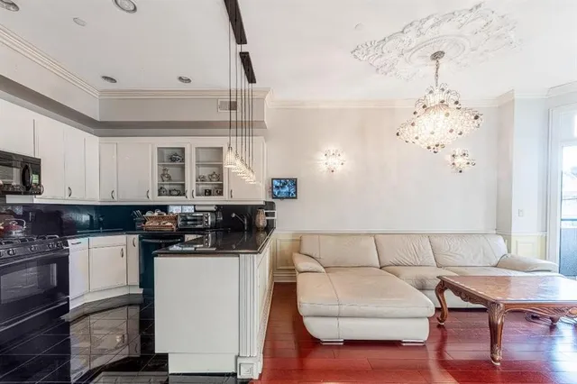 a kitchen with stainless steel appliances kitchen island granite countertop a sink and cabinets